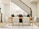 Dining room with light wood table, six beige chairs, and rug near staircase at 4076 Skyboat Cir, Fort Mill, SC 29715