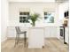 Modern white kitchen with island, stainless steel appliances, and white cabinets at 4076 Skyboat Cir, Fort Mill, SC 29715