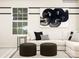 Modern living room with sectional sofa, ottomans, and black and white accents at 4076 Skyboat Cir, Fort Mill, SC 29715