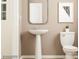 Modern powder room with pedestal sink and decorative mirror at 4076 Skyboat Cir, Fort Mill, SC 29715