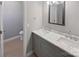 Bathroom with gray double vanity, marble countertop, and modern fixtures at 4127 Bon Rea Dr, Charlotte, NC 28226