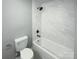 Bathroom with white bathtub, marble tile, and modern fixtures at 4127 Bon Rea Dr, Charlotte, NC 28226