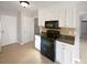 Kitchen with white cabinets, granite countertops, and black appliances at 4127 Bon Rea Dr, Charlotte, NC 28226