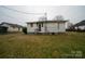 Backyard view of home showcasing yard and exterior features at 504 Glasgow Rd, Charlotte, NC 28214