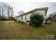 Side view of home and backyard showcasing yard and exterior features at 504 Glasgow Rd, Charlotte, NC 28214