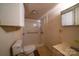 Bathroom featuring a tiled walk-in shower, a sink, a toilet, and a storage cabinet at 504 Glasgow Rd, Charlotte, NC 28214