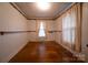 This is a bedroom with hardwood floors, built-in shelving, and vintage-style wallpaper at 504 Glasgow Rd, Charlotte, NC 28214