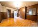 Spacious dining room featuring hardwood floors, vintage wallpaper and access to various rooms of the house at 504 Glasgow Rd, Charlotte, NC 28214