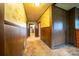 Hallway featuring vintage wallpaper, wood paneling and access to various rooms of the house at 504 Glasgow Rd, Charlotte, NC 28214