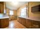 The kitchen is equipped with wooden cabinets, a sink, and retro wallpaper at 504 Glasgow Rd, Charlotte, NC 28214