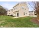 Backyard lawn features a green lawn, patio, and a view of the backs of townhomes at 528 Fawnborough Ct, Rock Hill, SC 29732