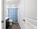 Modern bathroom featuring dark vinyl floors, shower with blue curtain and modern vanity at 528 Fawnborough Ct, Rock Hill, SC 29732