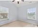 A bright bedroom featuring two large windows that offer natural light and neutral carpeting at 528 Fawnborough Ct, Rock Hill, SC 29732