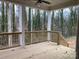 A covered back porch with a wooded view at 553 W Lowrance Ave, Mooresville, NC 28115