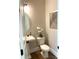 Charming powder room featuring a pedestal sink, round mirror, and a modern toilet at 553 W Lowrance Ave, Mooresville, NC 28115