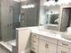 Spacious bathroom with a glass shower, and double vanity with marble countertop at 553 W Lowrance Ave, Mooresville, NC 28115