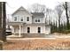 Two-story house with gray siding, a brick base, and a two-car garage at 553 W Lowrance Ave, Mooresville, NC 28115