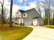 A charming two-story home with a two-car garage and a well-manicured lawn with beautiful green grass at 553 W Lowrance Ave, Mooresville, NC 28115