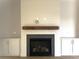 Modern fireplace with a wood mantel and built-in shelving at 553 W Lowrance Ave, Mooresville, NC 28115