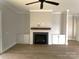 Fireplace with a wood mantel and white shiplap wall at 553 W Lowrance Ave, Mooresville, NC 28115