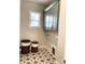 Well-lit laundry room with star patterned tile floors, blue cabinets, and wicker baskets at 553 W Lowrance Ave, Mooresville, NC 28115