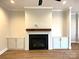 Cozy living room featuring a modern fireplace, built-in cabinets, and hardwood floors at 553 W Lowrance Ave, Mooresville, NC 28115