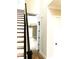 Wooden staircase with dark railing, leading to an open living area at 553 W Lowrance Ave, Mooresville, NC 28115