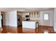 Kitchen with island, hardwood floors, and white cabinets at 704 W Border St, Dallas, NC 28034