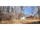 Private backyard with storage shed and tall trees at 704 W Border St, Dallas, NC 28034