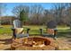 Backyard patio with fire pit and Adirondack chairs at 7219 Yellowhorn Trl, Waxhaw, NC 28173