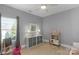 Neutral bedroom featuring a play kitchen and bright window views at 7219 Yellowhorn Trl, Waxhaw, NC 28173