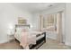 Bright bedroom featuring neutral colors, a large window, and a comfortable bed with stylish bedding at 7219 Yellowhorn Trl, Waxhaw, NC 28173