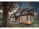 Brick exterior of a two-story home featuring a charming front porch, a well-manicured lawn and landscape beds at 7219 Yellowhorn Trl, Waxhaw, NC 28173