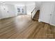 Bright living room with vinyl flooring, staircase, and bay window at 7310 Sun Dance Dr, Fort Mill, SC 29707