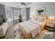 Virtually staged main bedroom with bay window and neutral decor at 7310 Sun Dance Dr, Fort Mill, SC 29707