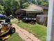 Backyard view featuring a lawn tractor and trailer at 784 Crestmont Se Dr, Concord, NC 28025