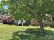 Charming brick home with a well-manicured lawn, mature tree, and inviting front porch at 784 Crestmont Se Dr, Concord, NC 28025