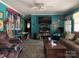 Bright living room with vibrant blue walls, a ceiling fan, and comfortable seating at 784 Crestmont Se Dr, Concord, NC 28025
