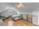 Upstairs bedroom with wood floors, and vintage refrigerator at 8478 Rocky River Rd, Harrisburg, NC 28075