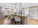 Modern kitchen featuring a large island with seating and granite countertops at 8478 Rocky River Rd, Harrisburg, NC 28075