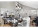 Open living area with spiral staircase, comfortable seating, and a view into the kitchen at 8478 Rocky River Rd, Harrisburg, NC 28075