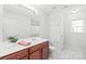 Bright bathroom with modern vanity, white countertop, decorative mirror and hexagon pattern floor at 8714 Summer Serenade Dr, Huntersville, NC 28078