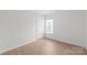 Bedroom with wood floors and a large window at 8714 Summer Serenade Dr, Huntersville, NC 28078