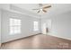 Primary bedroom featuring a ceiling fan and two windows with natural light at 8714 Summer Serenade Dr, Huntersville, NC 28078