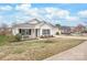 View of a well-maintained one-story home with neat landscaping and a cozy front porch at 8714 Summer Serenade Dr, Huntersville, NC 28078