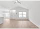 Open living space with wood floors, a ceiling fan, and abundant natural light at 8714 Summer Serenade Dr, Huntersville, NC 28078