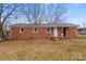 A single-story brick home with a cozy front porch and a well-maintained yard at 901 Wyke Rd, Shelby, NC 28150