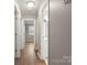 Well-lit hallway featuring luxury vinyl plank flooring leading to multiple rooms and a bathroom at 901 Wyke Rd, Shelby, NC 28150