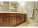 Double vanity bathroom with brown wood cabinets and drawers at 104 N Canyon Ridge Dr, Mount Holly, NC 28120