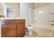 Clean bathroom with tub shower combo and wood vanity at 104 N Canyon Ridge Dr, Mount Holly, NC 28120